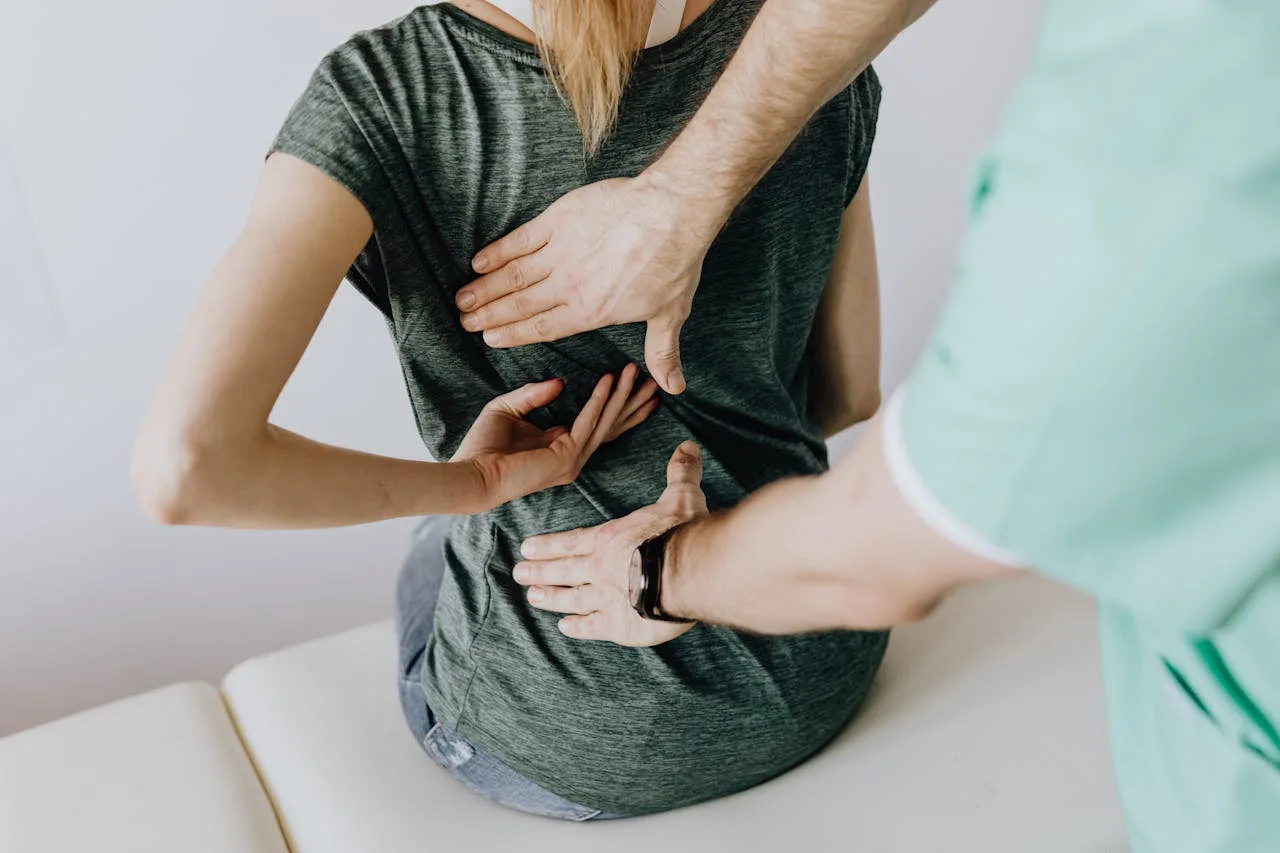 A clinician examining a patient's back for an acute pain flare-up