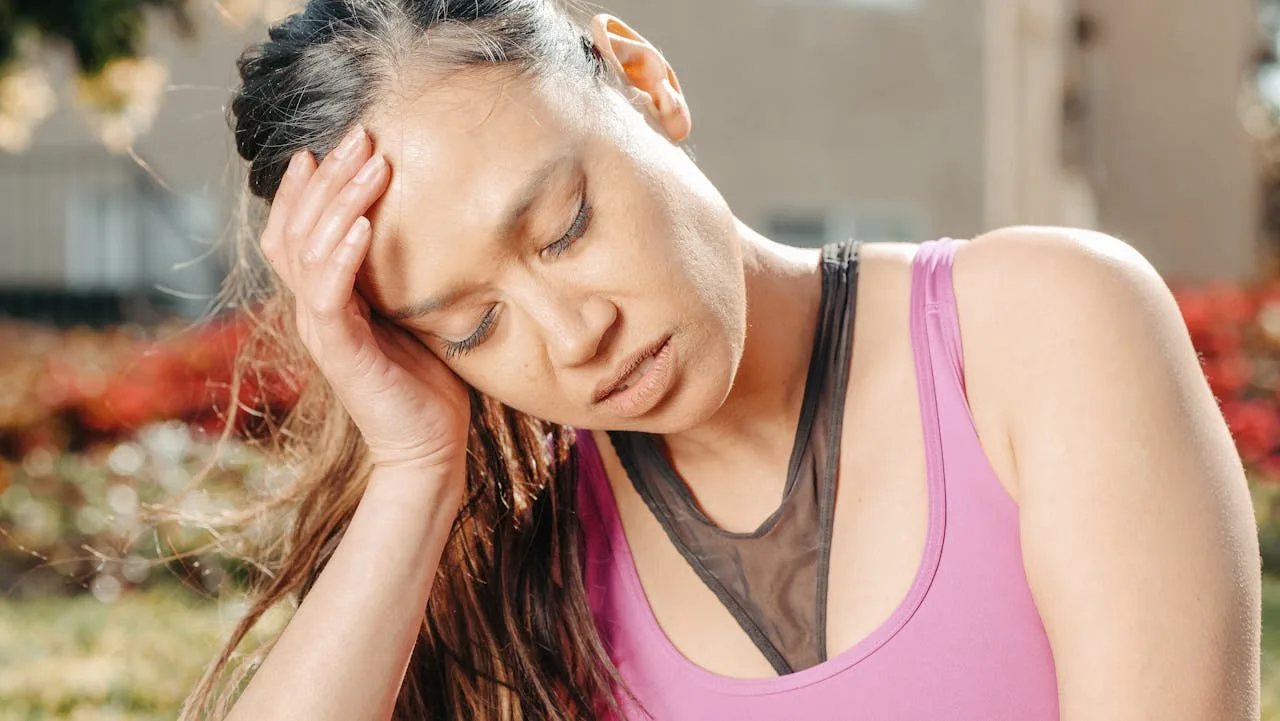 A patient dealing with a headache, representative of the acute concerns we treat same-day