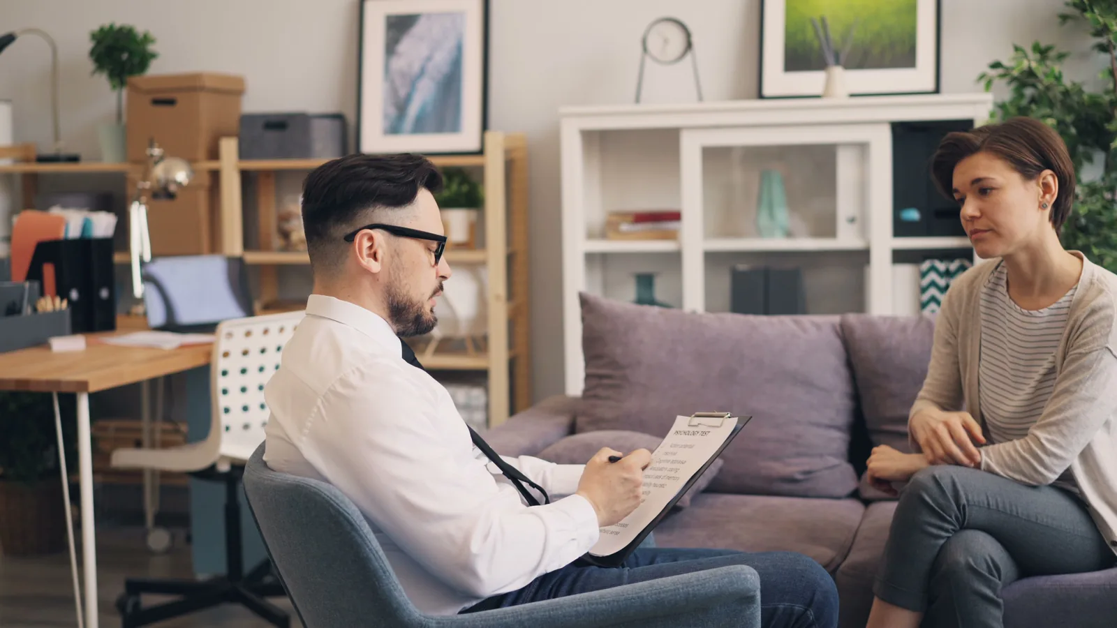 A clinician warmly discussing care details with a patient, representative of navigating insurance and coverage questions together