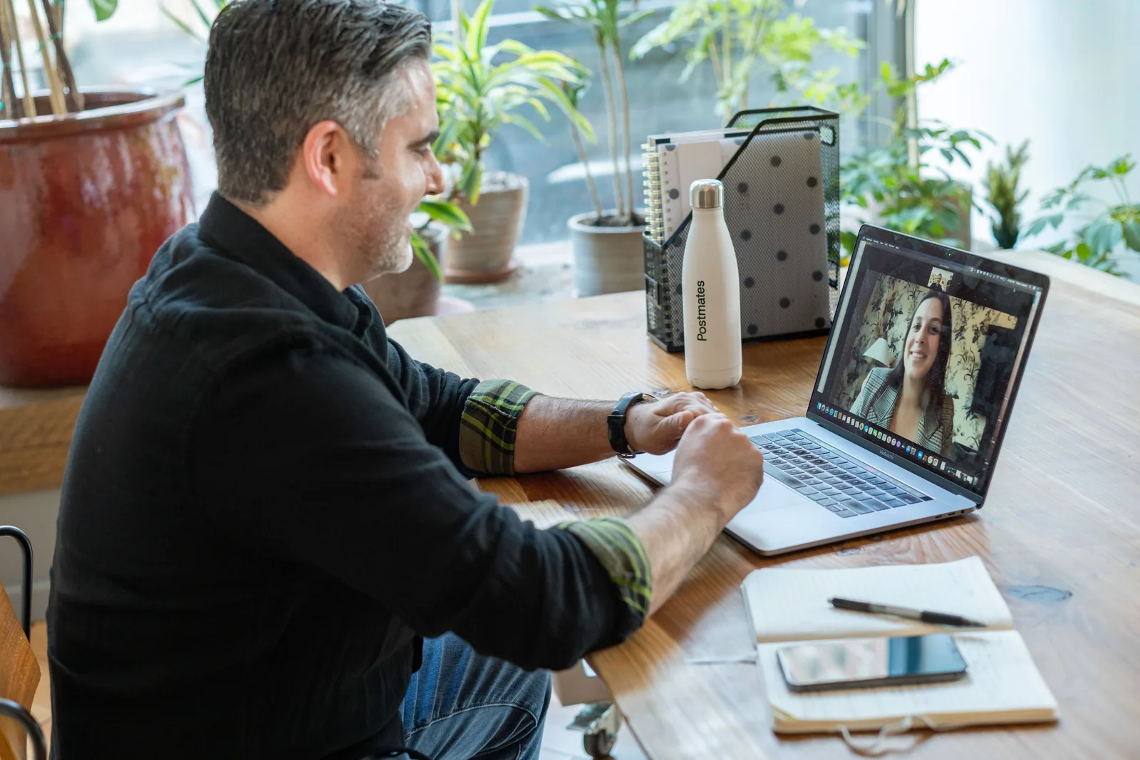 A patient talking with a clinician on a video visit from a sunny home office