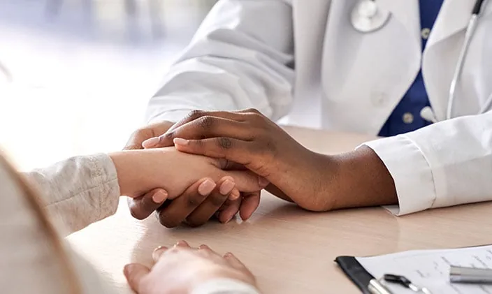 A physician offering compassionate, unhurried care to a patient