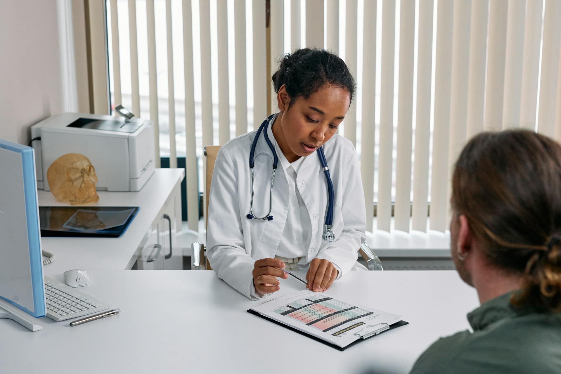 A physician reviewing test results with a patient during a diabetes visit