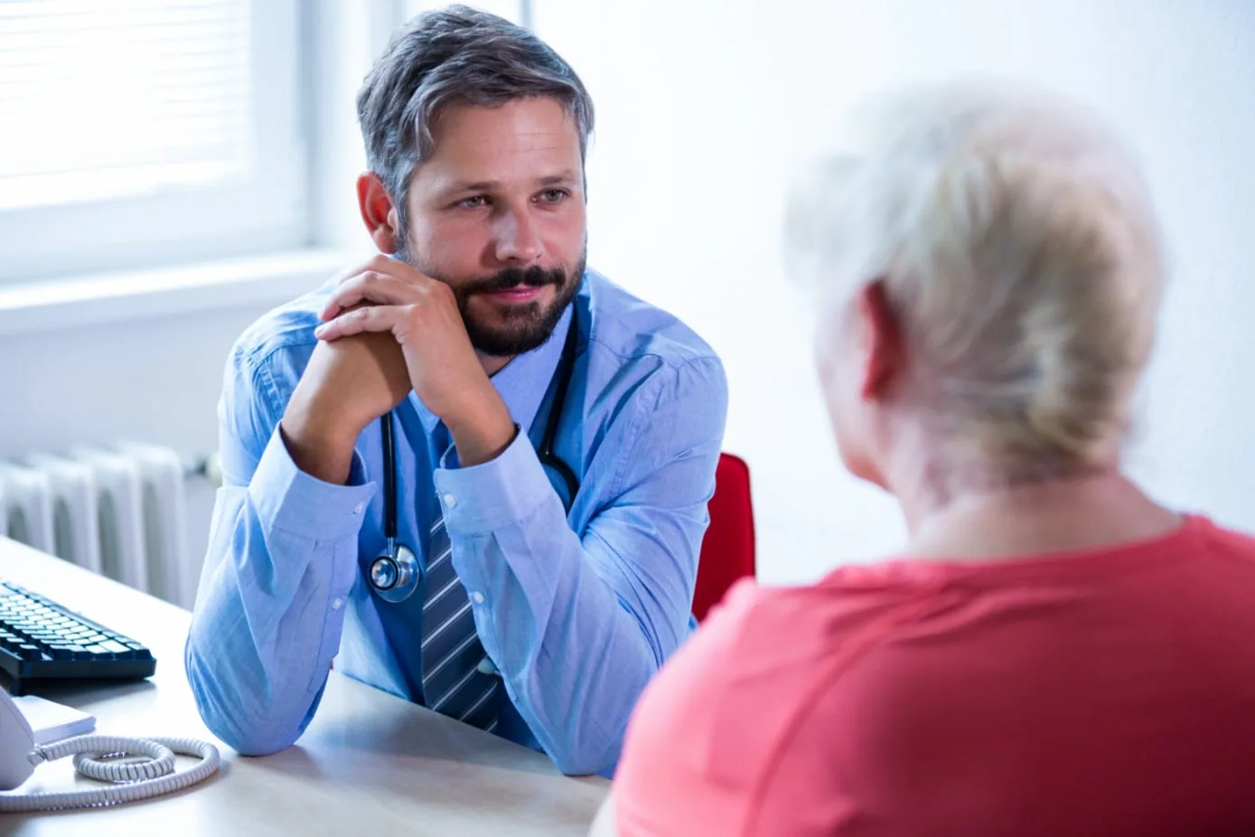 A physician listening attentively during a patient visit