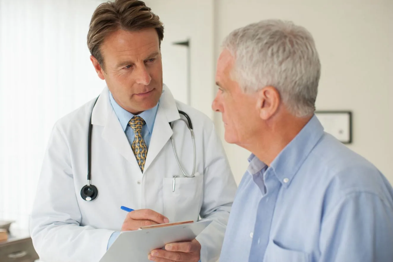 A physician discussing preventive screening options with a patient