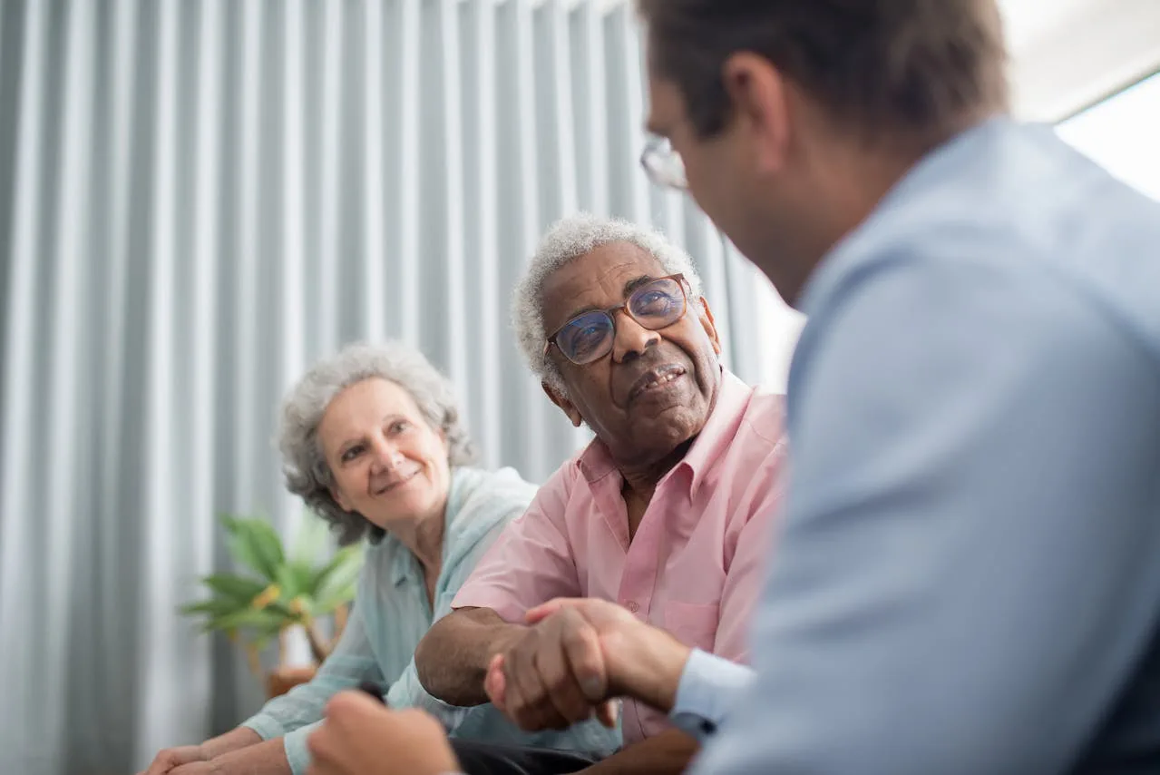 A multigenerational family in conversation, reflecting the long-term relationships the practice builds