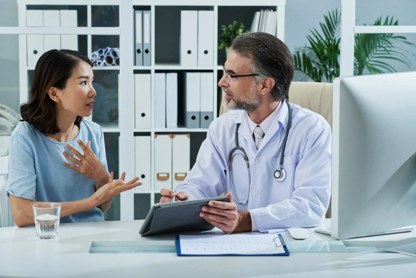 A physician listening closely to a patient's concerns during a consultation