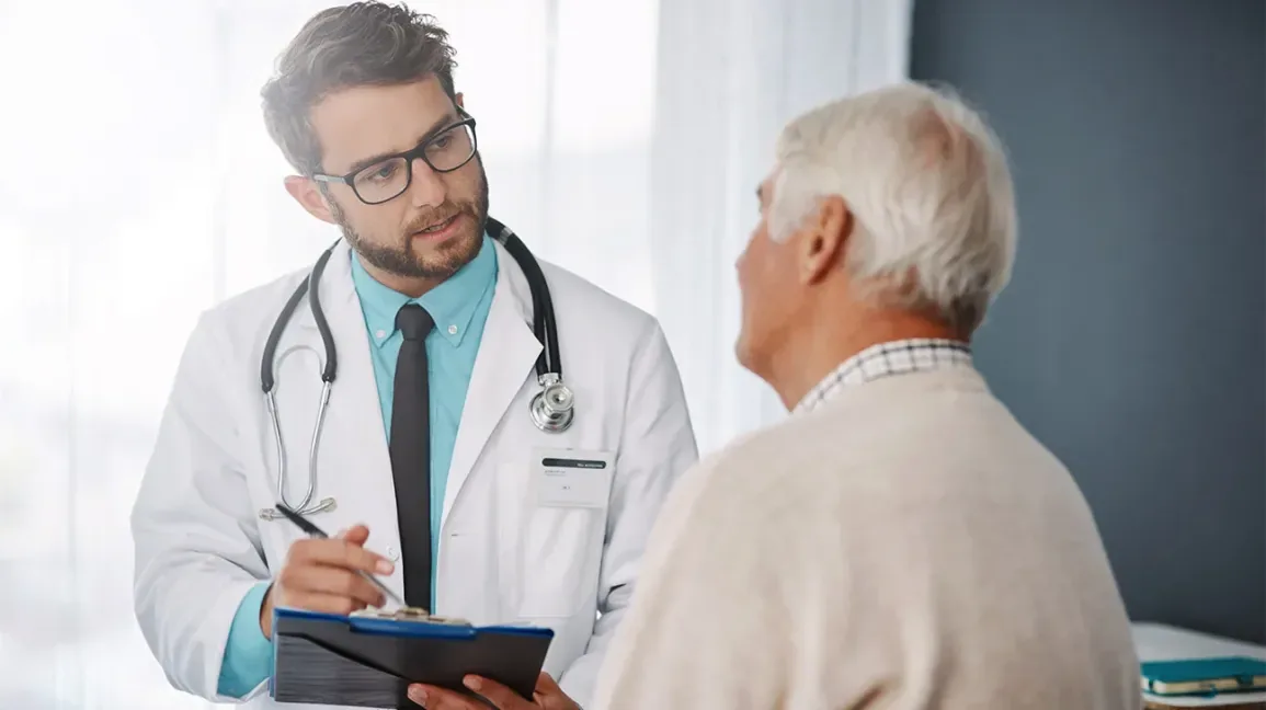 A physician reviewing treatment progress with a patient