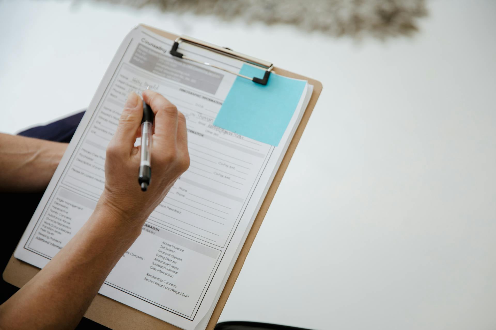 A clinician completing a confidential patient intake form