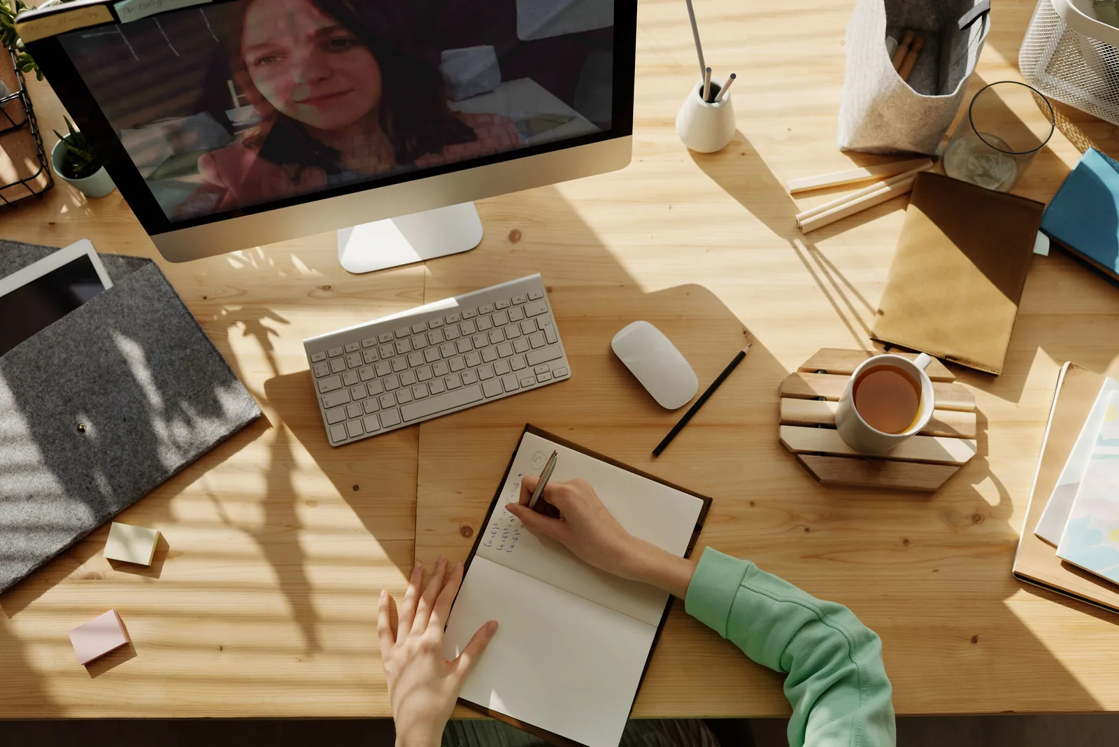 An overhead view of a telehealth consultation in progress, with handwritten notes, representative of reviewing qualifying conditions with a clinician