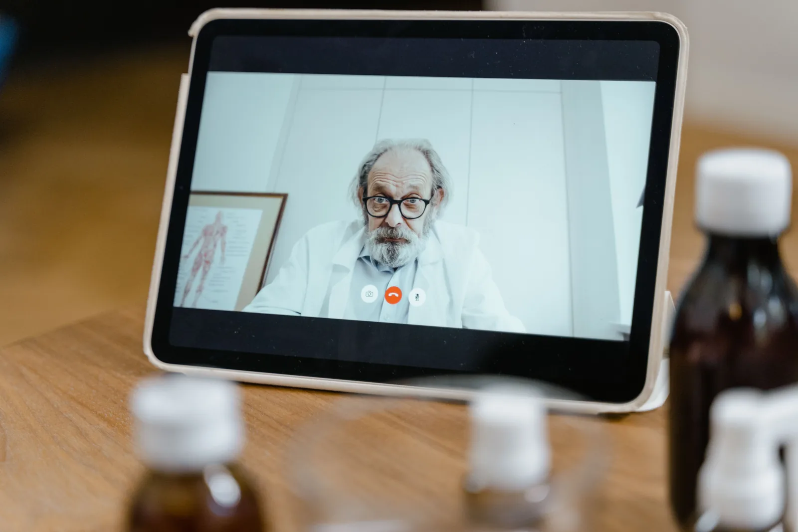 A clinician consulting with a patient via tablet video call, representative of the telehealth evaluation process for medical MJ certification